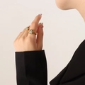 Vintage gold ring featuring a square Dalmatian stone inlay on model hand with black blazer - US Size 7 (Adjustable) / Gold Spotted Stone