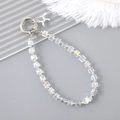 Macro shot of iridescent crystal beaded phone strap with metal balloon dog pendant - White (Balloon Dog Charm)