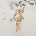 Close-up of gold flower watch dial with rhinestones and elegant quartz movement details - Rose Gold
