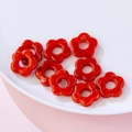 Nine red acrylic flower charms for DIY jewelry making displayed in a ceramic bowl - Red Marbled