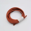 Macro detail of red-brown 6mm round leather cord with stitching for DIY bag handles - Tan