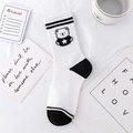 White crew socks with black stripes and cartoon bear pattern in a cozy lifestyle setting - Black White Bear (No.02 Star Bear)