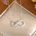 Elegant silver infinity symbol necklace with zircon stones on a gold jewelry box - A0107 Silver Infinity