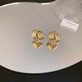Elegant gold spiral stud earrings featuring a textured geometric design on a reflective surface - 3D Spiral Texture Studs / Gold
