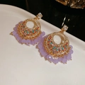 Macro shot of bohemian vintage drop earrings with colorful crystals and purple tassels - 28# Silver Pin Vintage Hollow Round Lavender Beaded Dangles