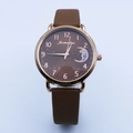 Detail of celestial dial featuring moon and star patterns with brown leather strap - Coffee