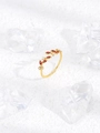 Macro shot of gold leaf-shaped ring with red marquise gems and white pavé stones - Red