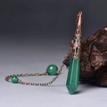 Macro detail of a green hexagonal crystal pendulum with ornate copper floral metal cap - Antique Bronze Green Aventurine