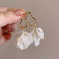 French style flower earrings with wavy gold metal hoops and white pleated shell petals - Zircon Shell Earrings