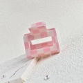 Detail shot of the pink and white checkered hair claw clip on a white stone background - Pink/White 5cm Grid Clip