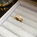 Detail of 18k gold plated criss-cross ring with white enamel and pavé zircon stones - Gold