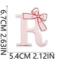 Detail of pink embroidered letter R patch with a delicate bow for DIY clothing decor - Pink Letter R