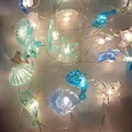 Macro shot of LED ocean theme fairy lights with seashell starfish and seahorse pendants - 10 Styles Mixed / 1m 10-LED 2AA Battery Box (Steady On)