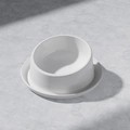 Minimalist white ceramic pet bowl with tilted ergonomic stand on stone surface - Glazed White