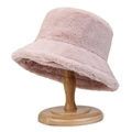 Plush faux fur bucket hat in pink, warm winter headwear displayed on wooden stand - Pink