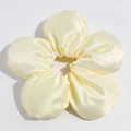 Detail view of a bright yellow satin flower scrunchie with smooth silk texture - Yellow (Approx. 18cm)