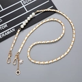 Golden leather chain phone strap with large faux pearls and camellia charm accessory - Crossbody Chain / White