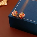 Macro detail of multi-colored crystal flower earrings on a luxury jewelry box - Silver Earring Post - Gold - Colorful