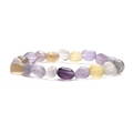 Macro view of natural amethyst and quartz crystal beads on a colorful stone bracelet - Fluorite