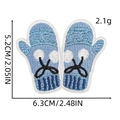 Detail of light blue embroidered mitten patch with white pom-pom and heart, 6.3x5.2cm - Glove Shape Style