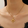Gold stainless steel tiger eye necklace featuring a sunburst pendant on model - Gold Cross Sun Necklace Style (8467)