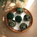 Detailed view of six dark green velvet Christmas balls with gold glitter patterns in a tray - Dark Green Velvet Gold Pattern (Q-A02-57)