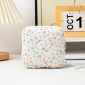 Detailed shot of quilted floral sanitary bag on a desk with aesthetic lifestyle background - 12.5*12.5*5cm / Red Green Blue Ditsy Floral