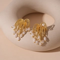 Macro shot of gold textured metal earrings with fireworks fringe and white pearls - Gold Firework Tassel Drop Earrings (925 Silver Needle)