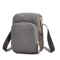 Grey nylon crossbody phone bag featuring three gold zippered compartments and strap - Gray