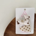 Close-up of handmade beige polka dot fabric hair clips with a bird and triangle design - Duck Hair Clip Set