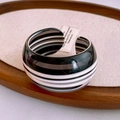 Close-up of vintage black and white striped wide cuff bangle on a wooden tray - Black White Striped Wide Resin Bangle (42#)