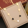 Golden snake chain necklace with black and white enamel heart charms on a jewelry box - 1# Necklace