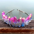 Detailansicht der rosa-blauen Kristallkrone mit Silbermond und Kämmen auf Holz - Lila Blau
