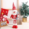 Plush Christmas Santa doll with ski board and red knit hat for festive holiday decor - Large / Santa Claus