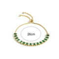 Detail of adjustable gold bracelet with green emerald cut and clear cubic zirconia stones - Adjustable Bracelet