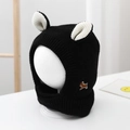 Detail of black baby knitted hat with white ears and cute puppy embroidered patch - Infant and Toddler Universal Size / Embroidered Dog Earflap Hat / Black
