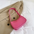 Pink baguette shoulder bag in smooth faux leather on a beige blazer background - Rose Red