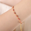 Gold-tone evil eye bracelet with vibrant red beads and adjustable extension chain on wrist - Red Bracelet