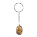 Macro detail of natural tiger eye stone keychain with polished oval brown agate pendant - Tiger Eye