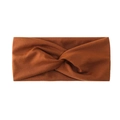 Close-up detail of the brown twisted stretch headband, soft fabric for sports and yoga wear. - Tan