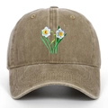 Close-up of intricate narcissus flower embroidery on washed cotton vintage dad hat - Khaki
