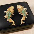 Close-up of golden carp earrings with blue and red crystals on black jewelry box - Gold-Blue Red Rhinestones (S925 Silver Pin)