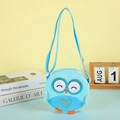 Detail of blue plush owl crossbody bag featuring sequined eyes and a heart pattern - Blue