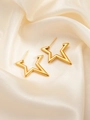 Detailed close-up of golden star-shaped titanium steel earrings on beige silk fabric - Star E0270 Style