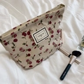 Detail of corduroy makeup bag with red floral pattern and pleasant time label - Cream Rose