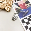 Silver skull pendant with small flower detail for DIY jewelry making and necklace crafts - 1Pc Flower Skull 3x21mm