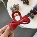 Close-up of a glossy red bow hair claw clip featuring a durable golden metal spring - Approx. 8cm / Bright Red