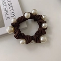 Detail shot of dark brown fabric scrunchie with pearls and decorative book background - Dark Coffee