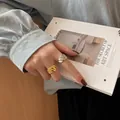 Chic vintage style gold and silver twisted rope ring set worn by model on a book - Ripple Twisted Style (TJZ173)