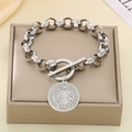 Macro shot of silver stainless steel Saint Benedict medal with OT toggle clasp and bead chain - Silver Bracelet